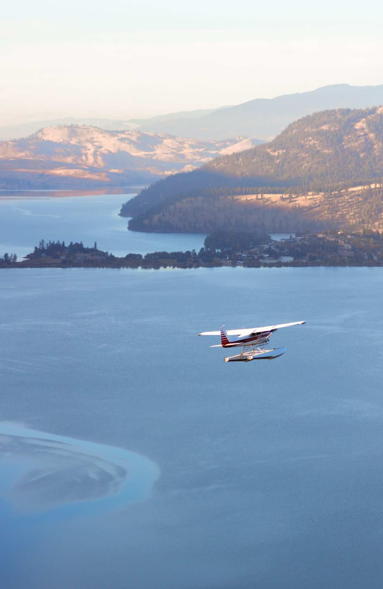 floatplane in the distance over Kalamalka Lake in British Columbia