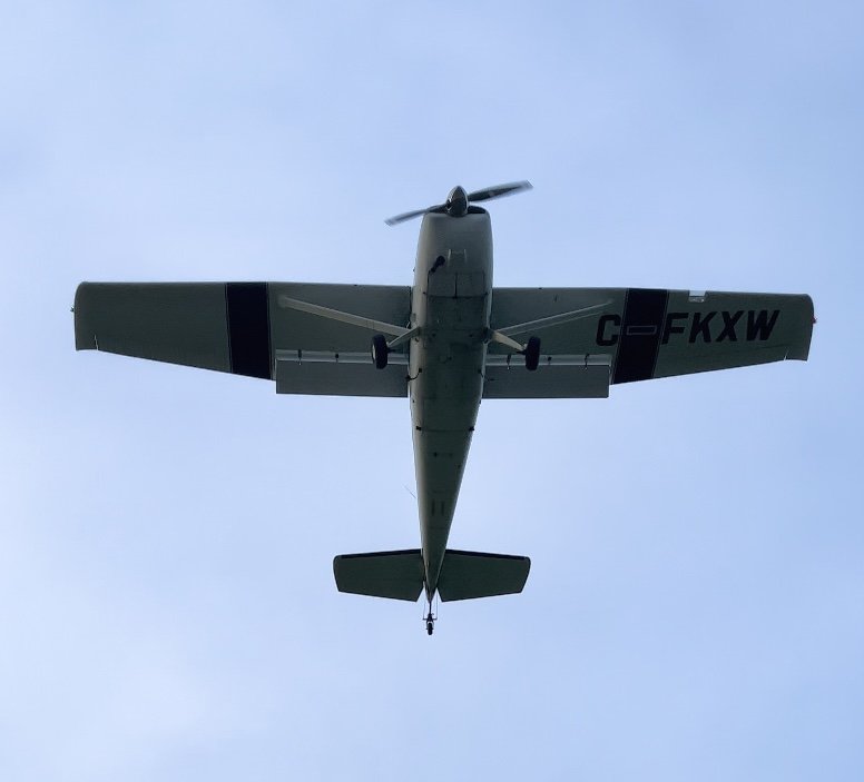 tailwheel plane in flight from below