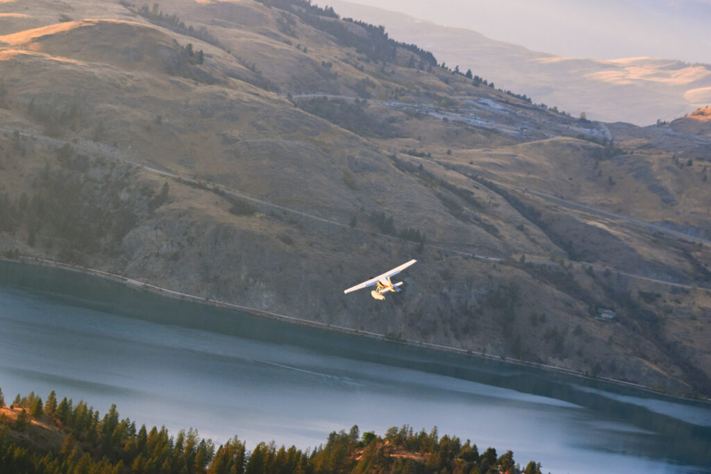 float plane in flight over Okanagan Lake